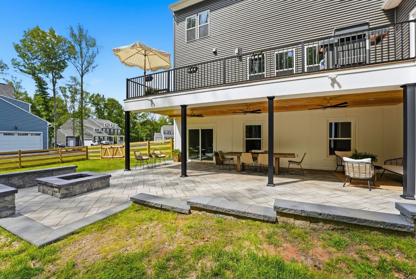 Deck, covered patio and square stone fire pit