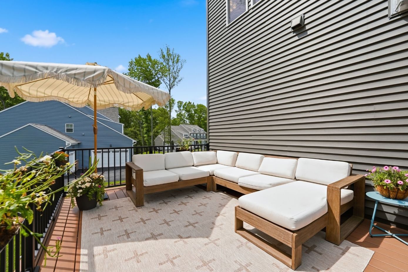 Second-story deck with sectional seating and umbrella